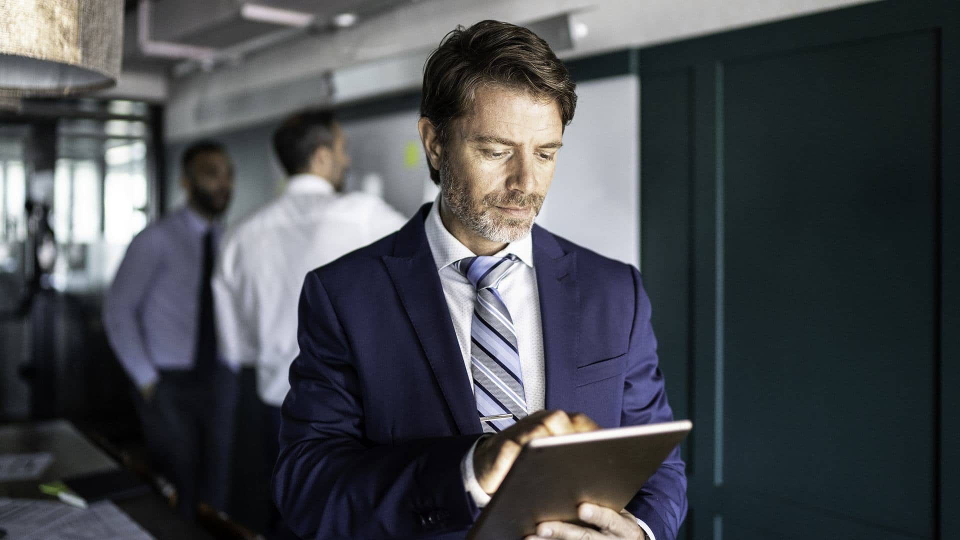 Businessman using a digital tablet at board room