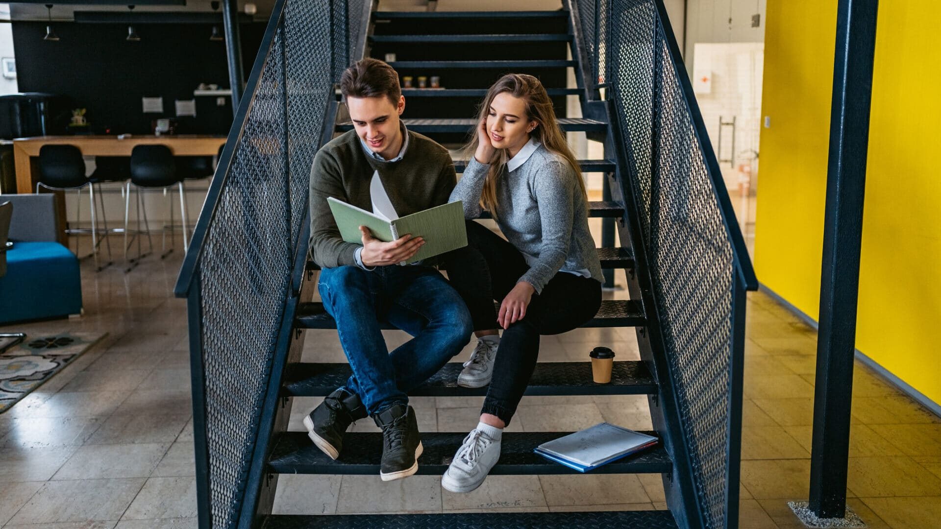 Two university student studying on stairs