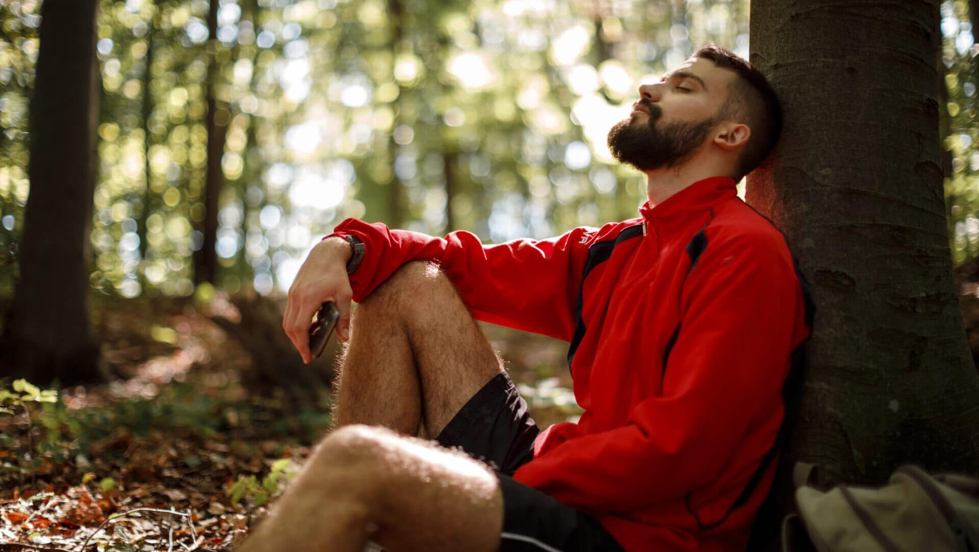 Young man relaxing in forest