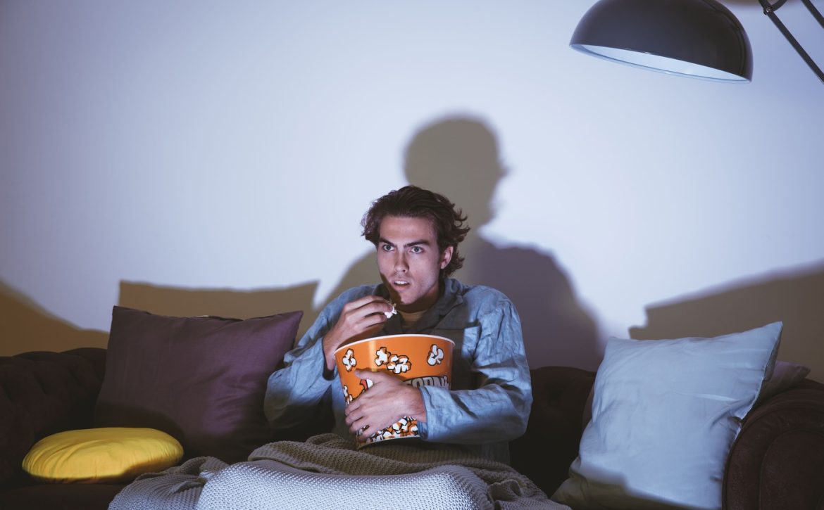 uomo-che-guarda-un-film-e-mangia-popcorn (1) (1)
