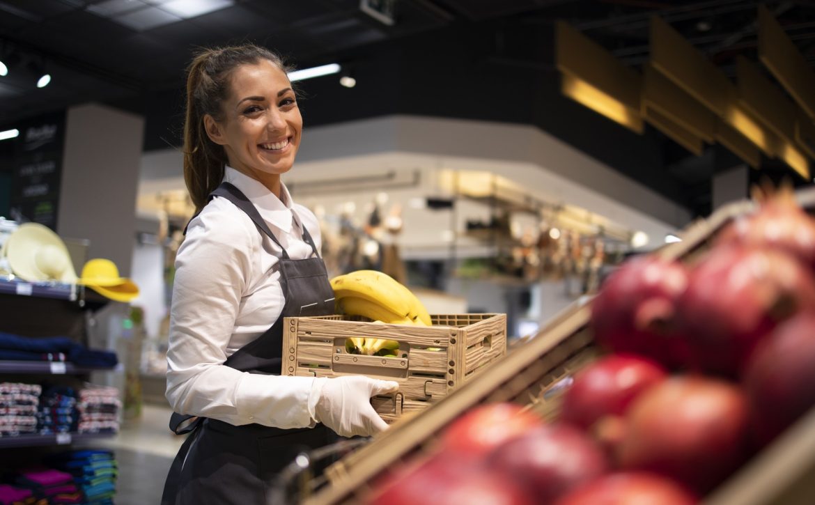 supermarket-worker-supplying-fruit-department-with-food (1) (1)